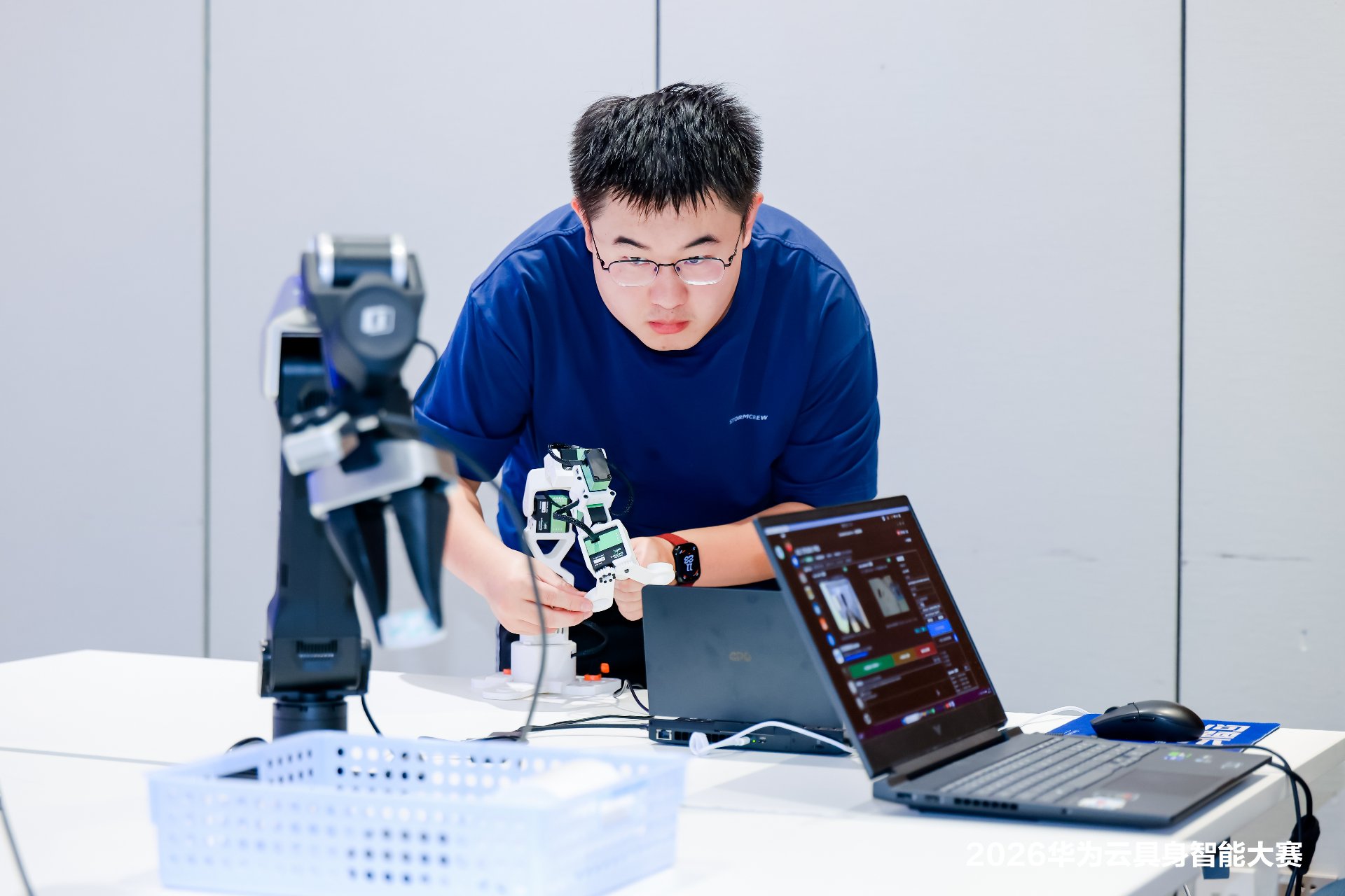 A participant captures demonstration data with a Star Arm 102 leader arm